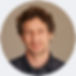 circular image of person facing the camera. The circle has a colored circle round it.